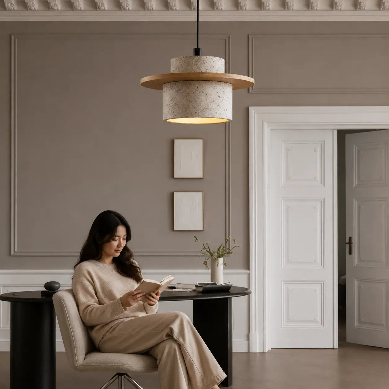 Aro stone pendant light creating a quiet warm bedside atmosphere in a neutral bedroom