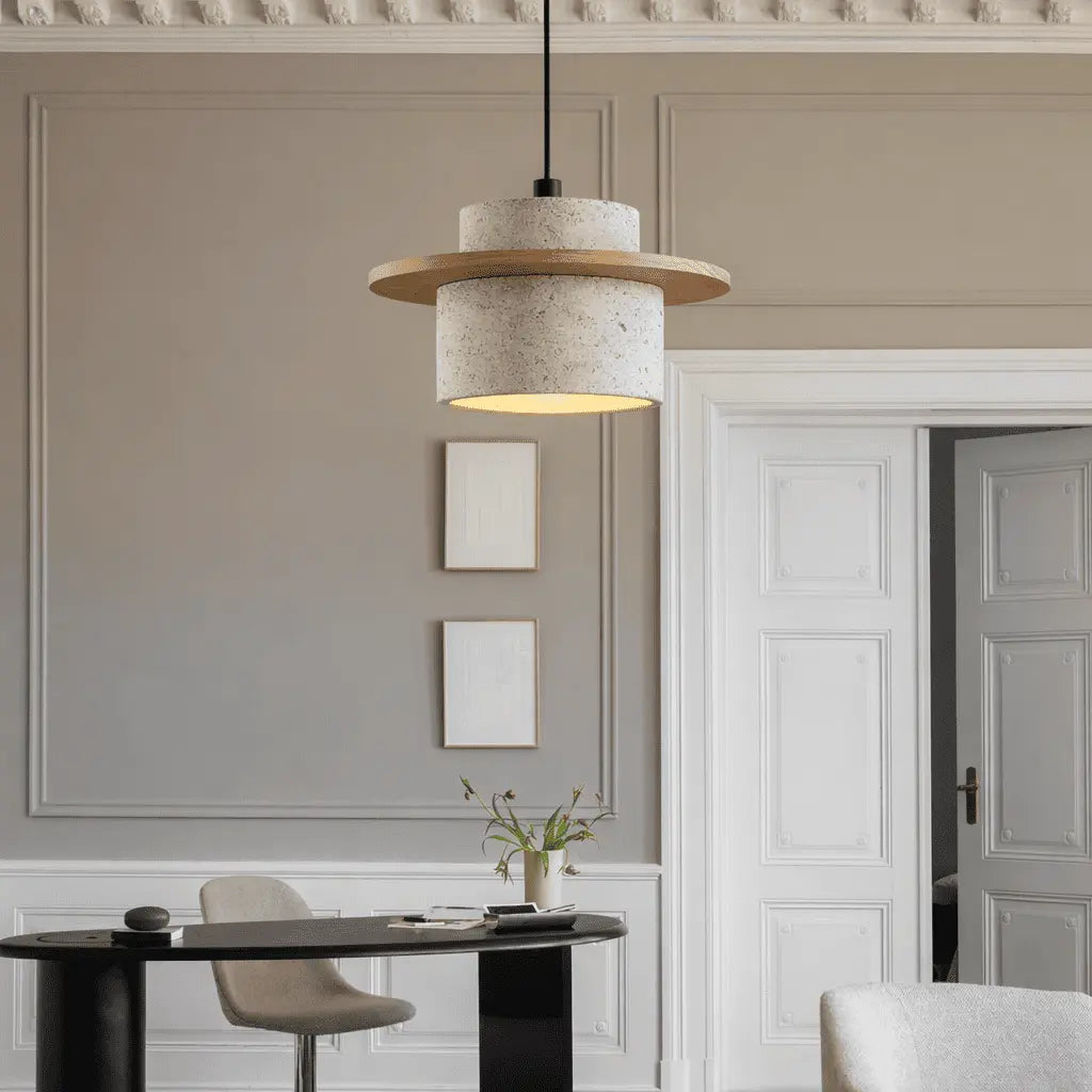 Aro stone pendant light suspended above a bright modern dining table