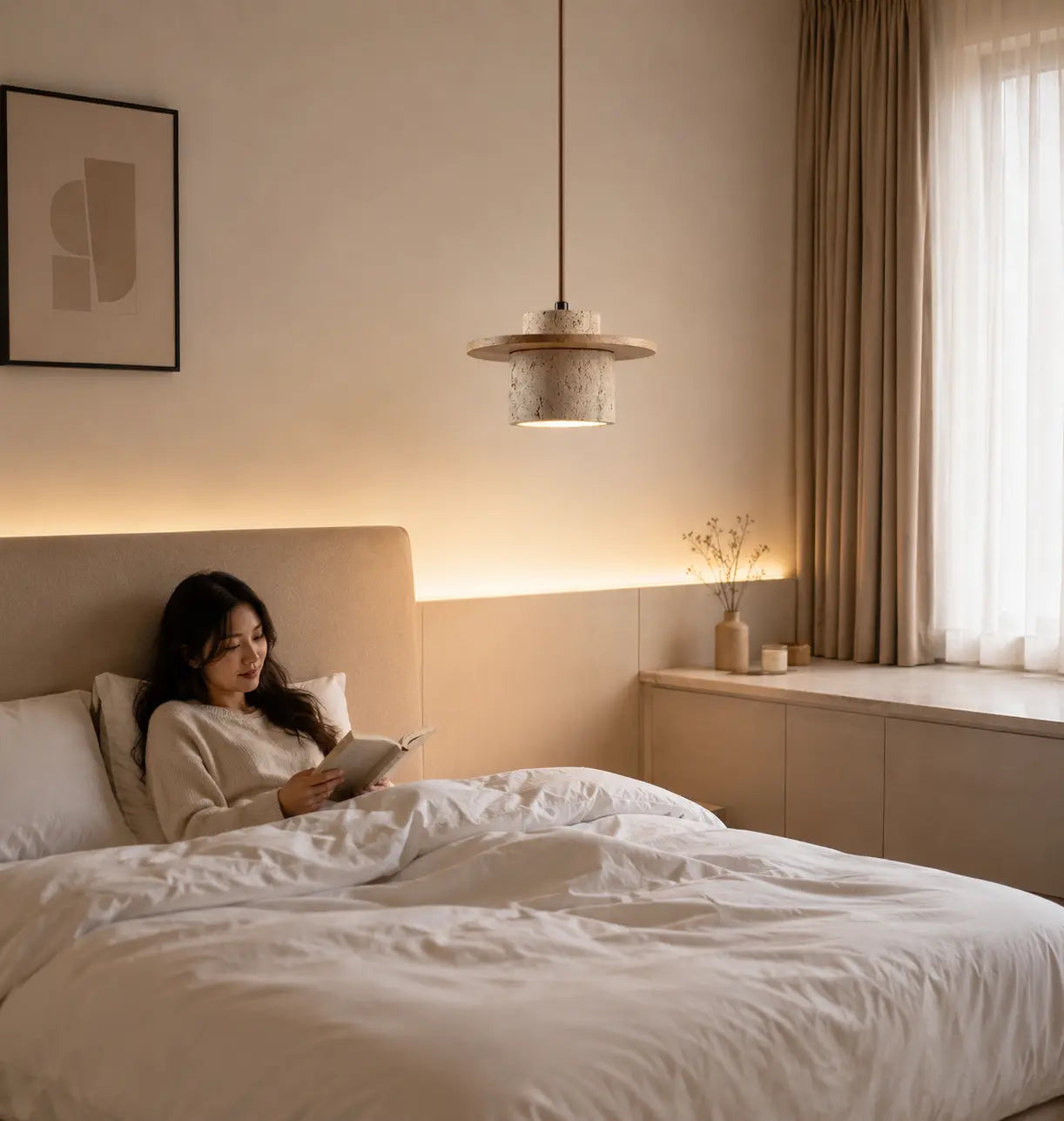 Aro stone pendant light adding a soft warm glow beside a bed during the evening1