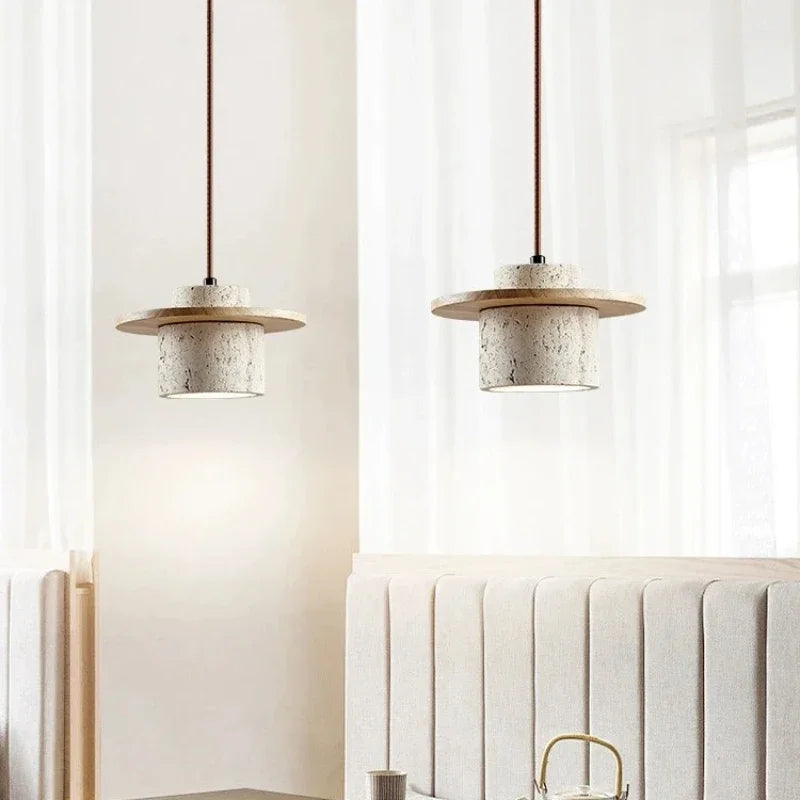 Multiple Aro stone pendant lights suspended in a warm neutral interior