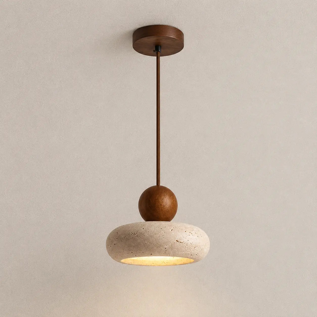 Arova stone pendant light with a round wood accent, textured stone shade, and warm downward glow