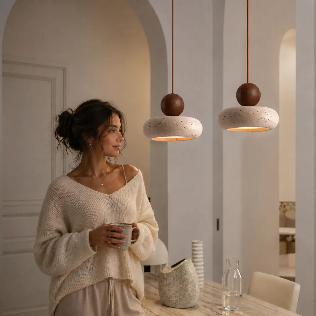 Arova stone pendant light creating a soft warm accent in a calm home interior
