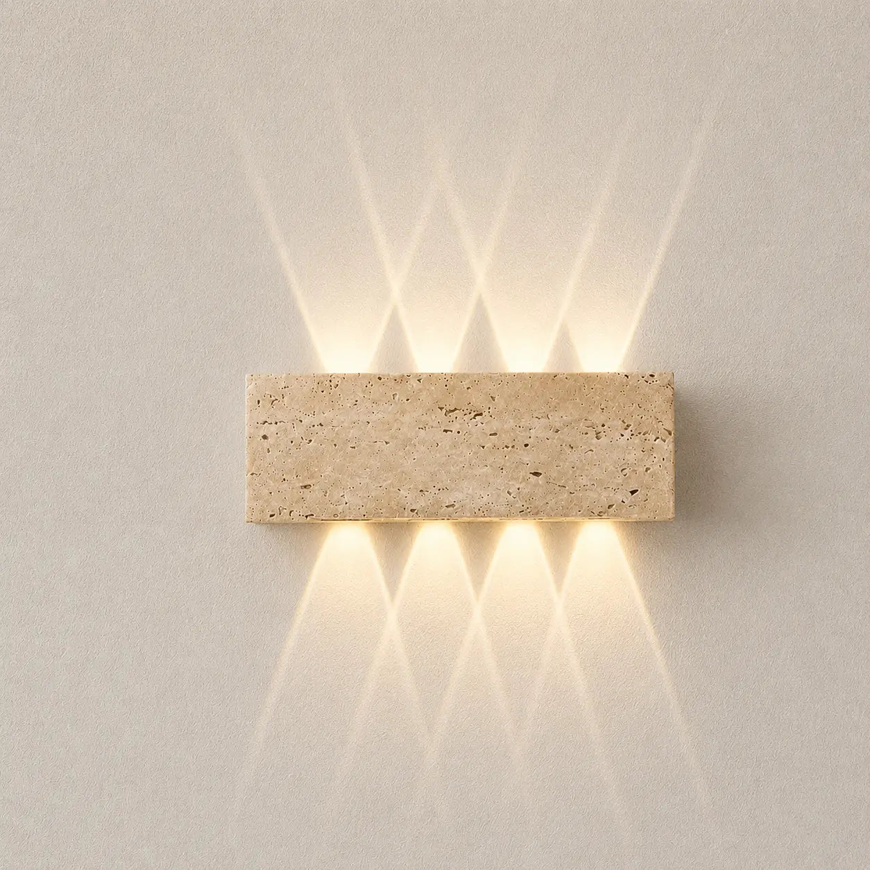 Aure stone wall light with a rectangular textured stone shade and soft warm up-and-down glow