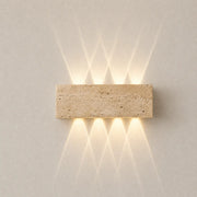 Aure stone wall light with a rectangular textured stone shade and soft warm up-and-down glow
