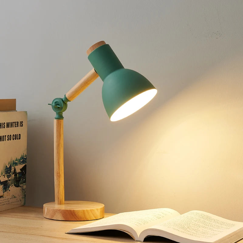 Aureline Nordic desk lamp in green creating focused warm light over an open book