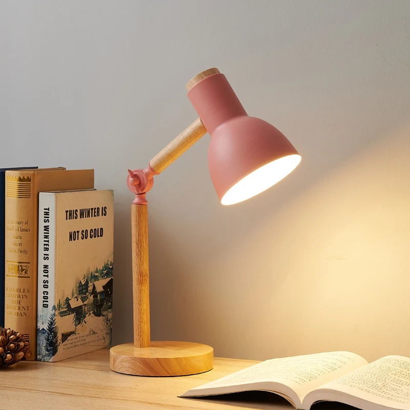 Aureline Nordic desk lamp in pink with a warm wood base and adjustable angled shade