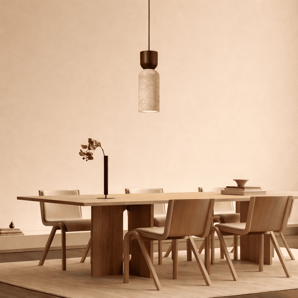 Auren stone pendant light creating focused warm light above a dining table