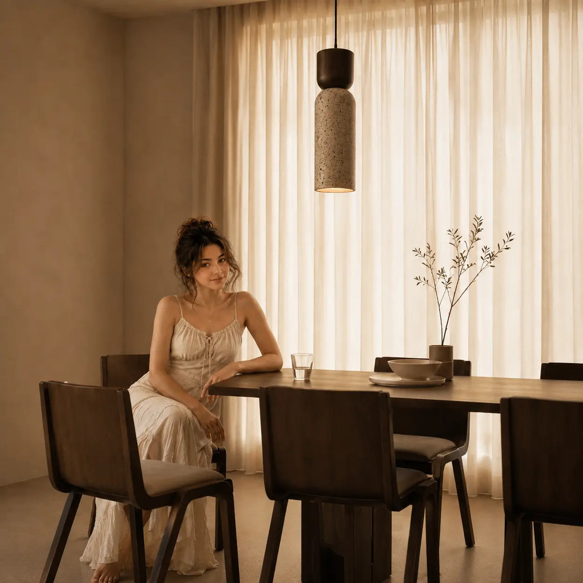 Auren stone pendant light bringing soft warm illumination to a kitchen and dining space