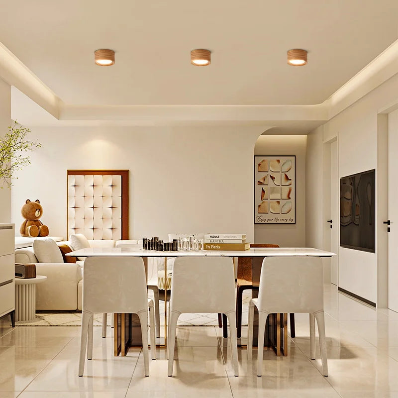 Auro wooden ceiling light creating soft warm overhead light in a modern dining room