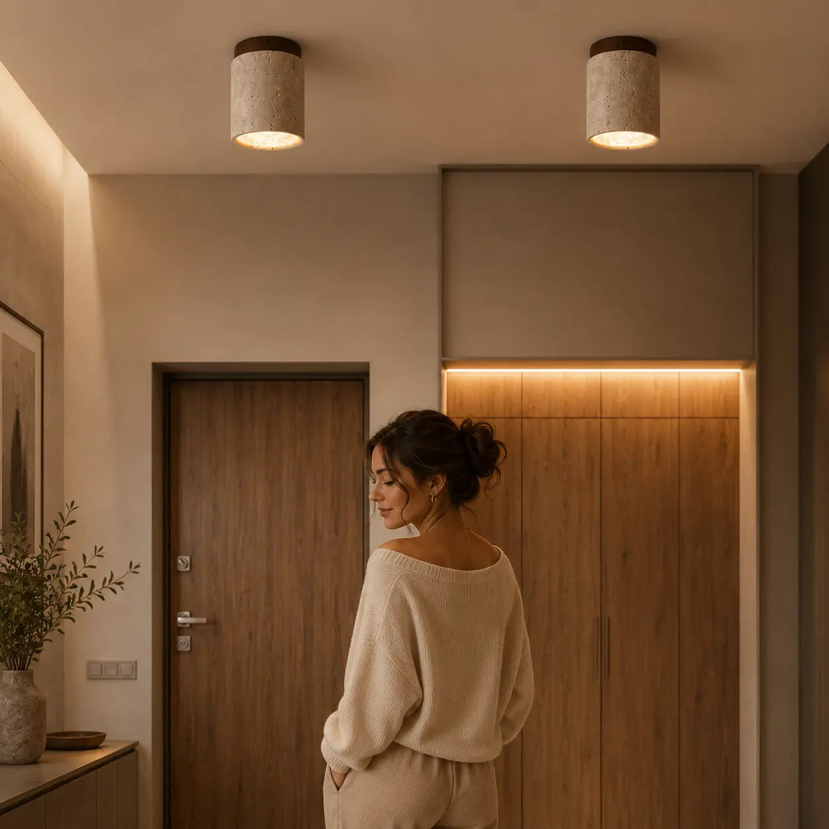Aven stone ceiling light creating warm overhead illumination in an evening corridor