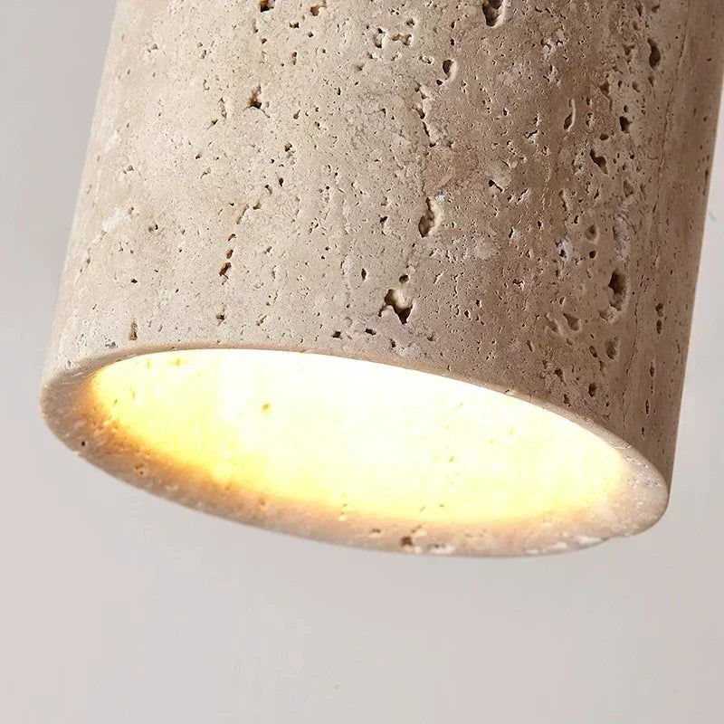 Close-up of the Aven stone ceiling light textured shade with warm diffused illumination