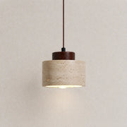 Ciela stone pendant light with a textured stone shade, dark wood top detail, and warm downward glow