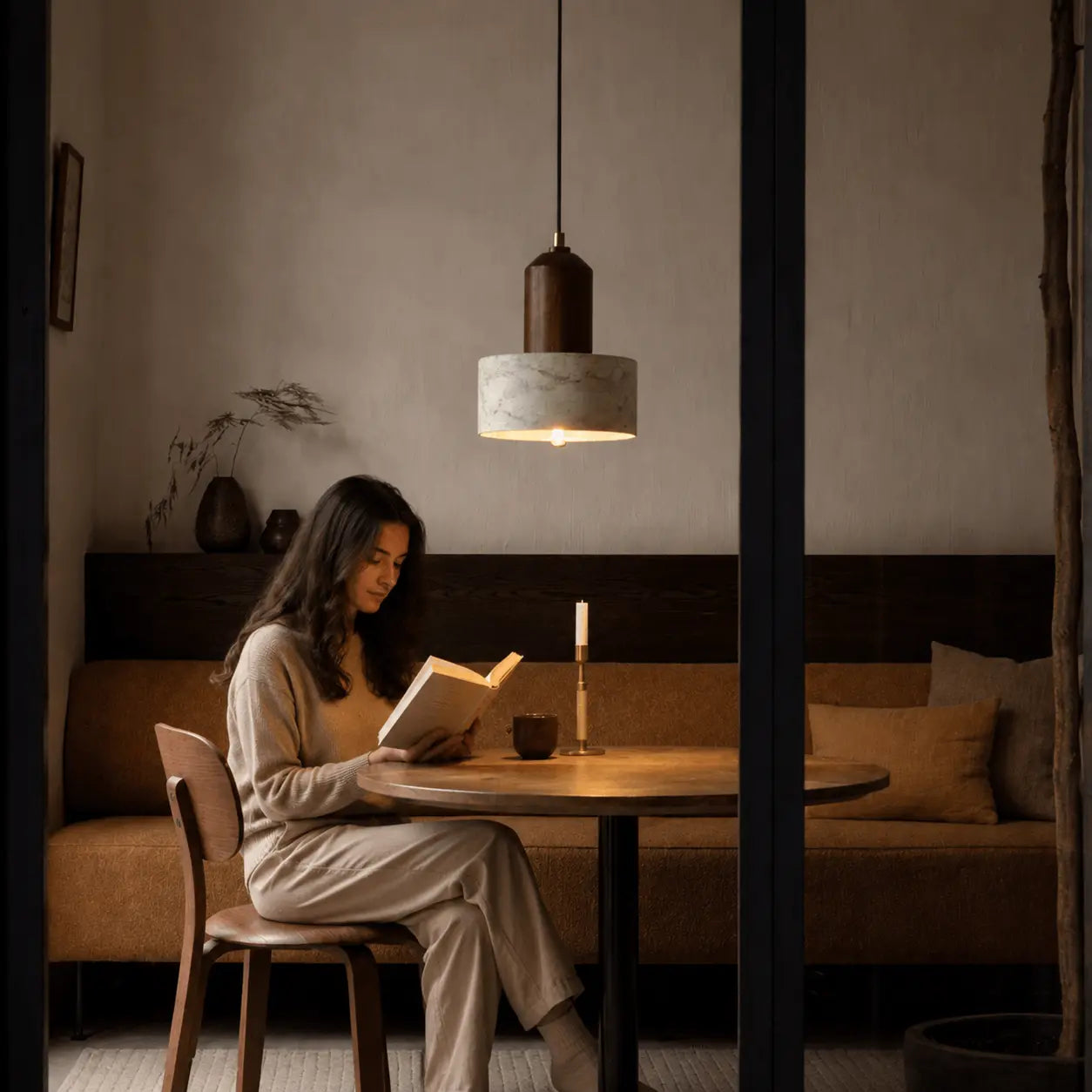 Eira stone pendant light adding warm evening atmosphere to a calm dining room