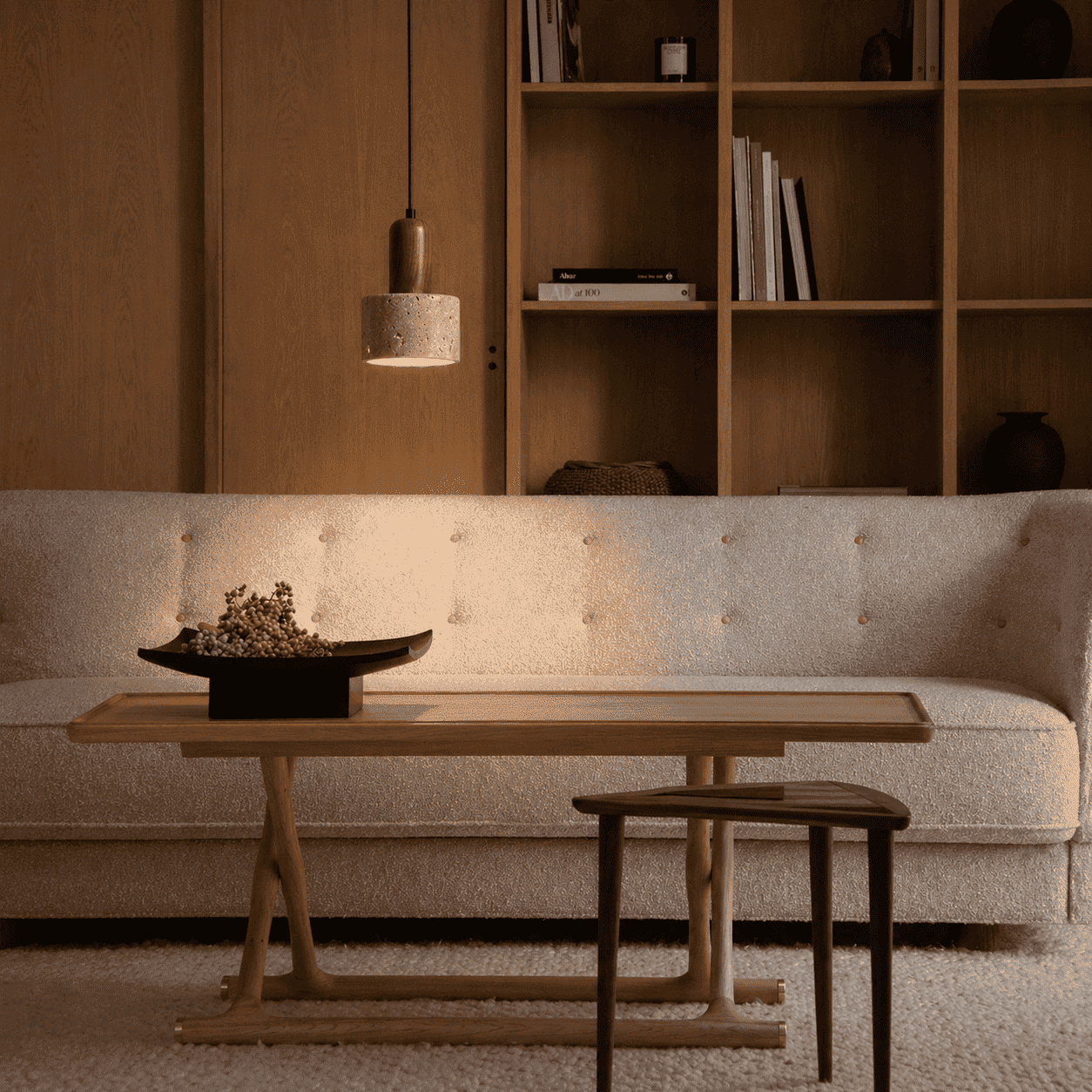 Eira stone pendant light creating intimate overhead lighting for an evening dining setting