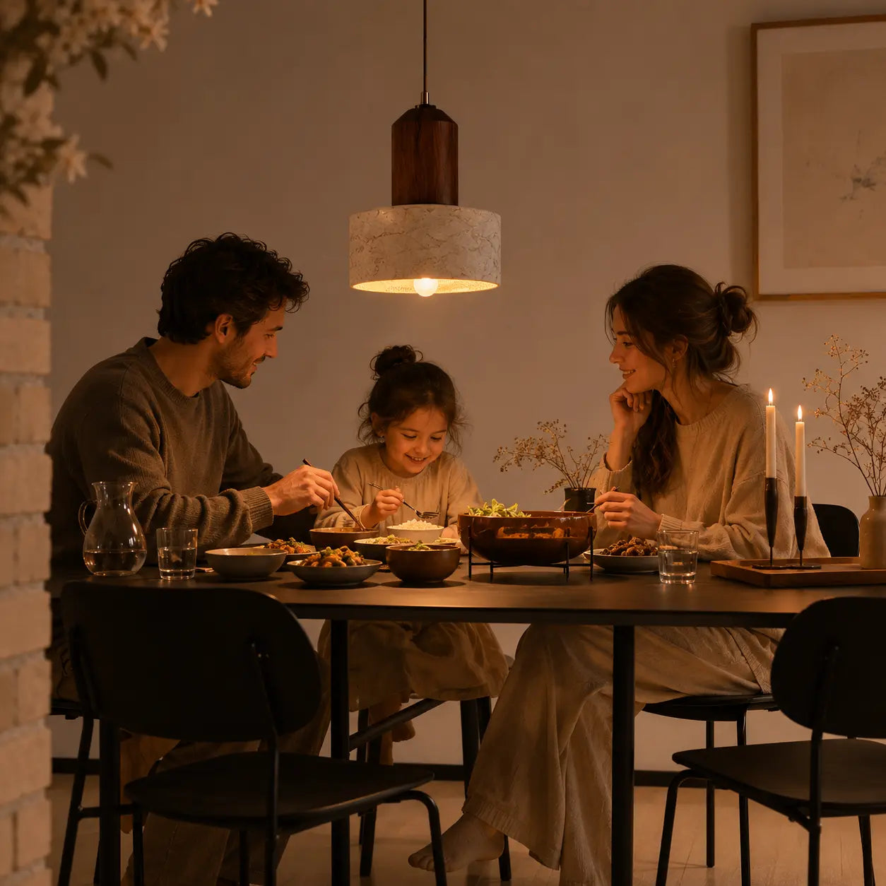 Eira stone pendant light creating intimate overhead lighting for an evening dining setting