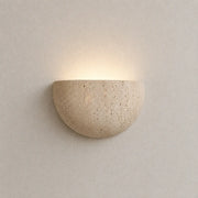 Liora stone wall light with a half-round textured stone shade and soft warm upward glow