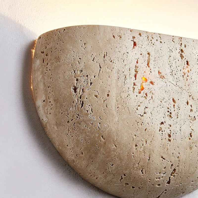 Close-up of the textured stone finish on the Liora wall light shade