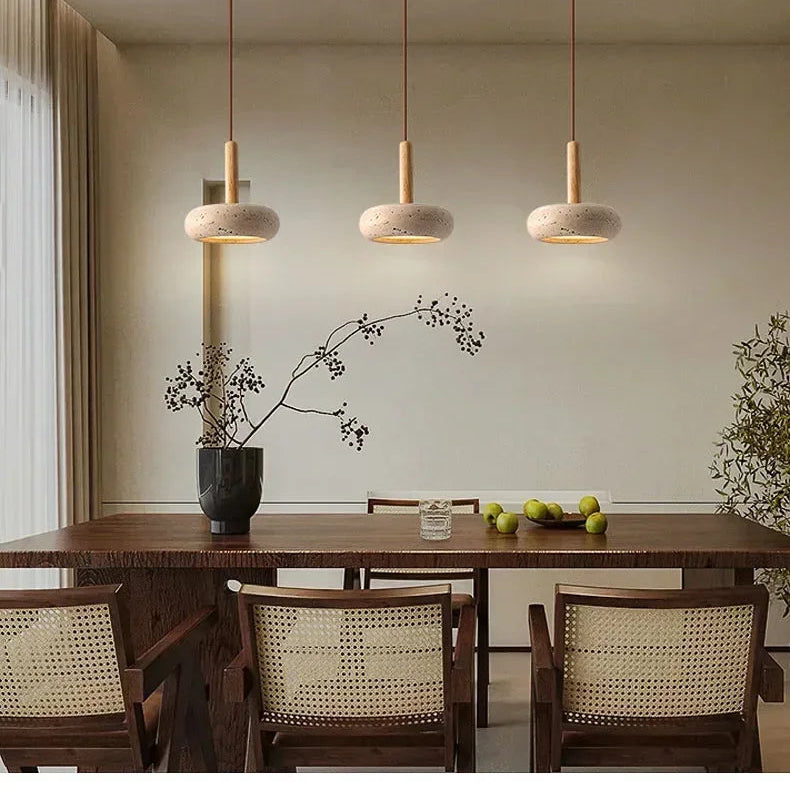 Lume stone pendant lights creating warm focused illumination above a dining table