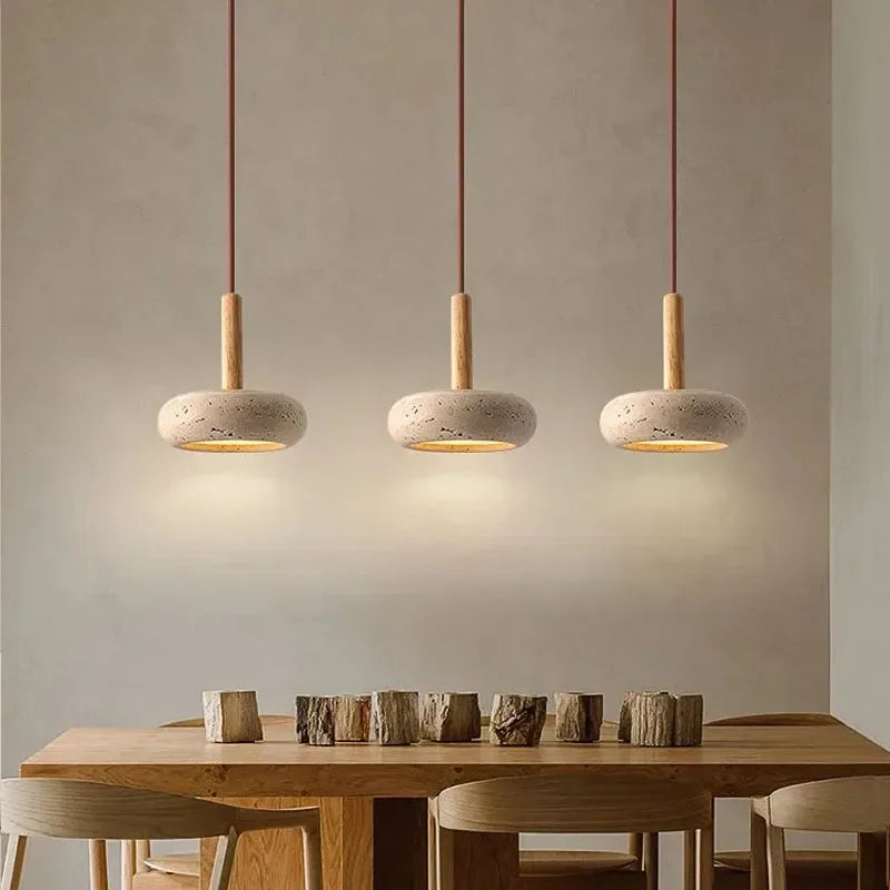 Lume stone pendant lights creating soft warm lighting above a kitchen shelf