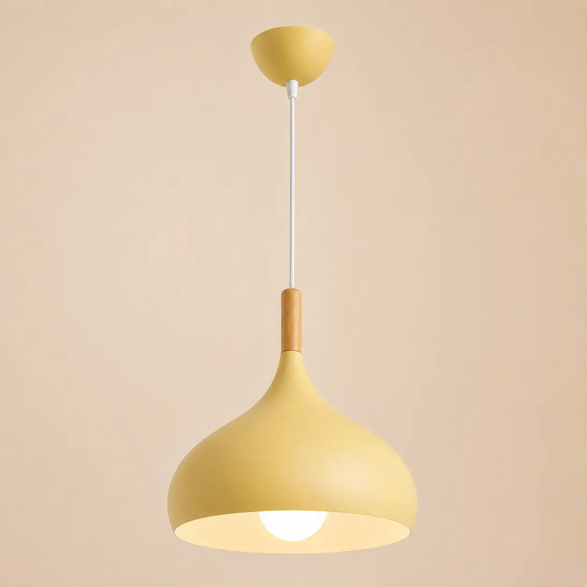 Lunara Nordic pendant light in yellow with a rounded shade, slim cord, and warm diffused glow