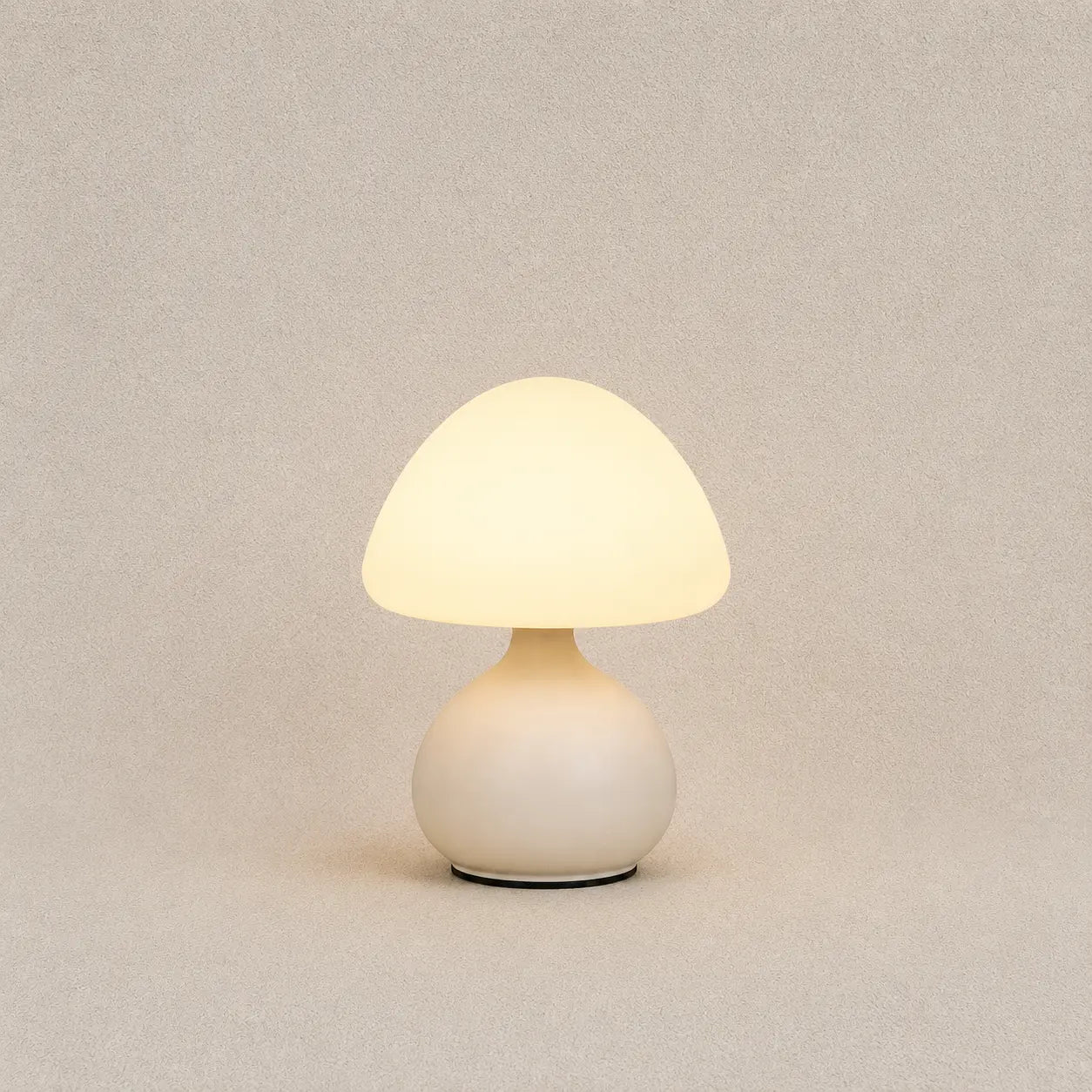 Lunelle mushroom table lamp with a soft white rounded shade, compact base, and warm diffused glow