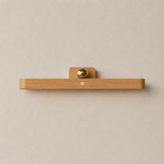 Lunor magnetic wall light with a natural wood bar design and soft warm diffused glow