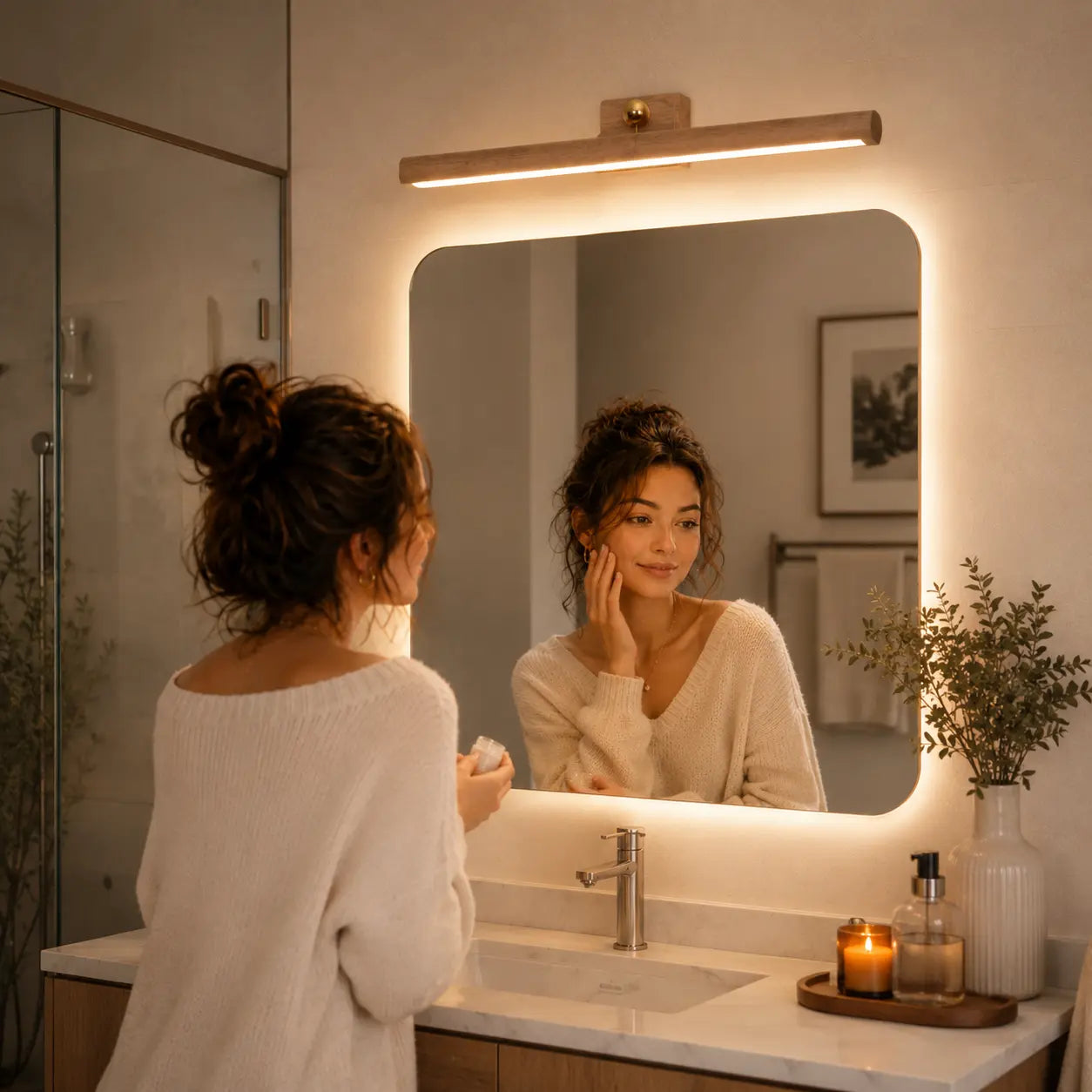 Lunor magnetic wall light creating soft warm illumination above a vanity mirror