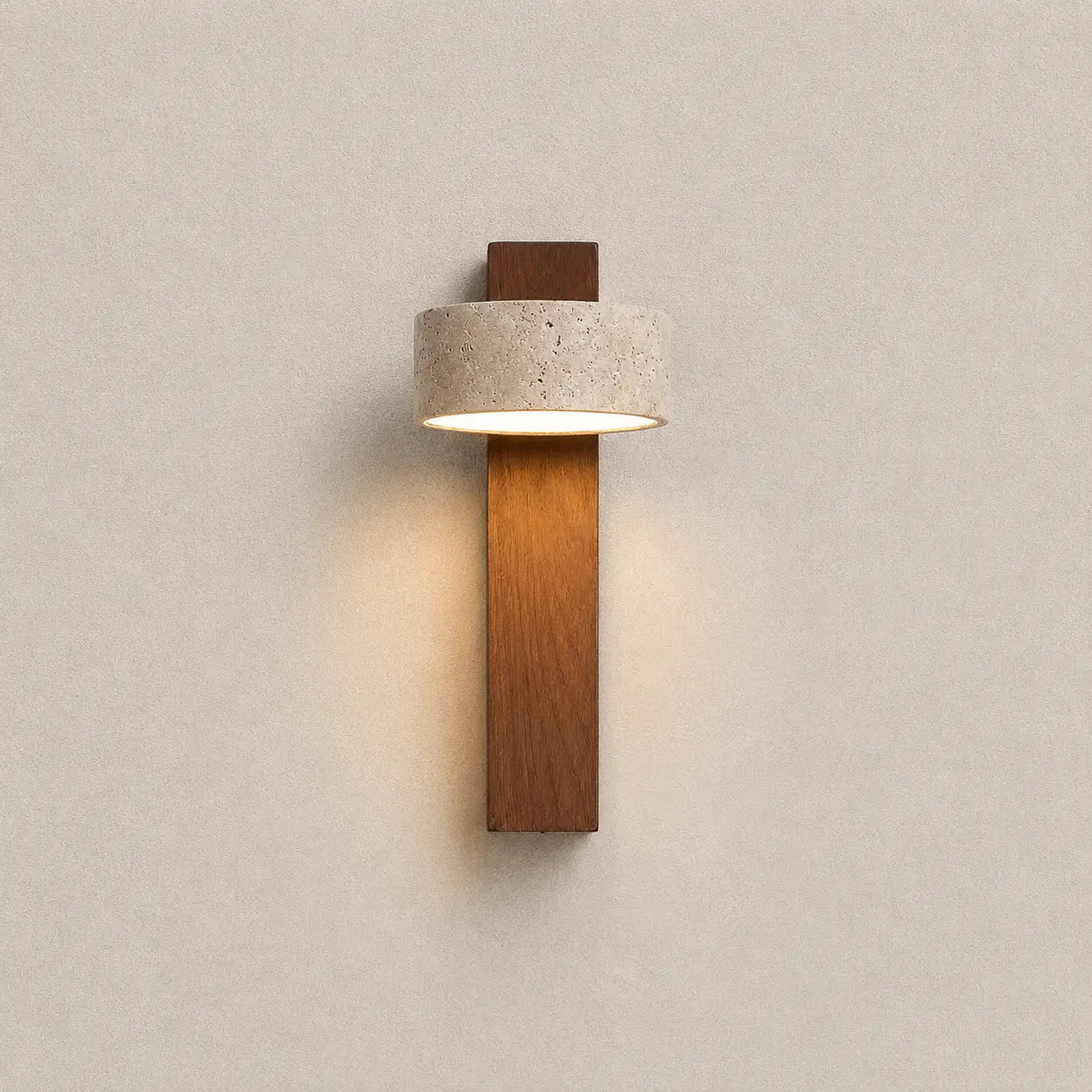 Miro travertine wall light with a vertical wood body, textured stone shade, and warm downward glow