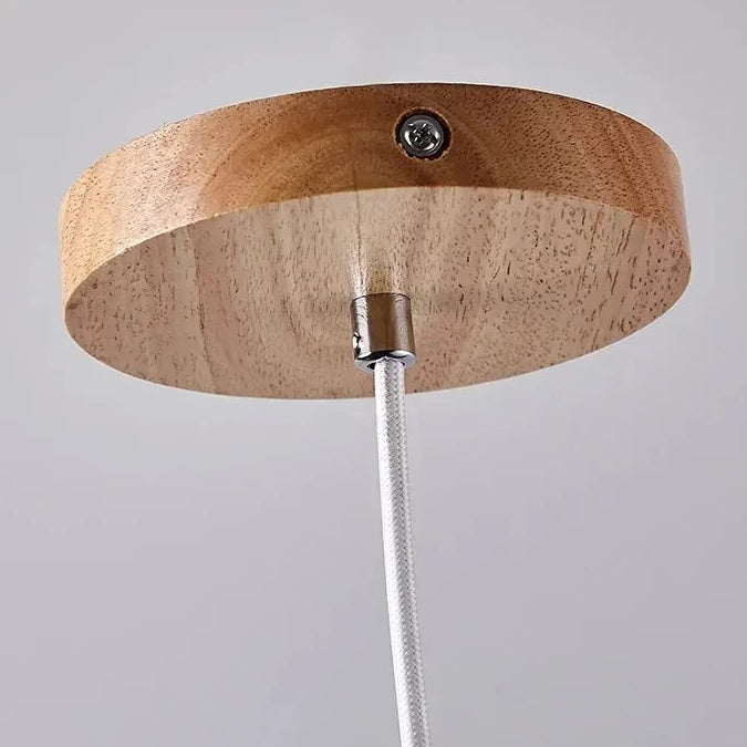Close-up of the Neri travertine pendant light ceiling canopy and hanging cord detail