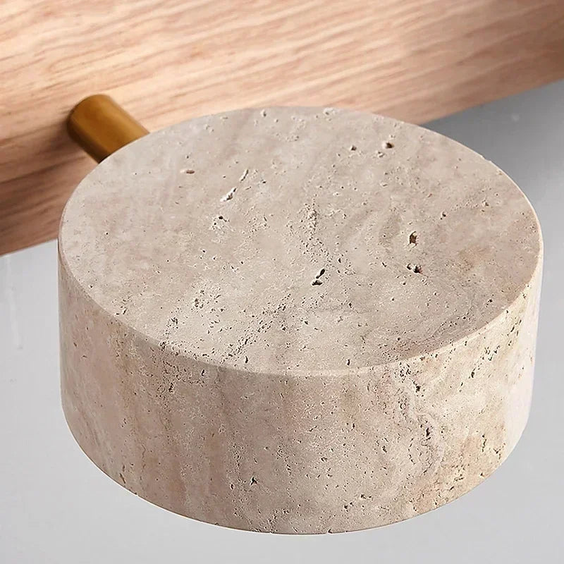 Close-up of the natural travertine stone texture used on the Oren wall light