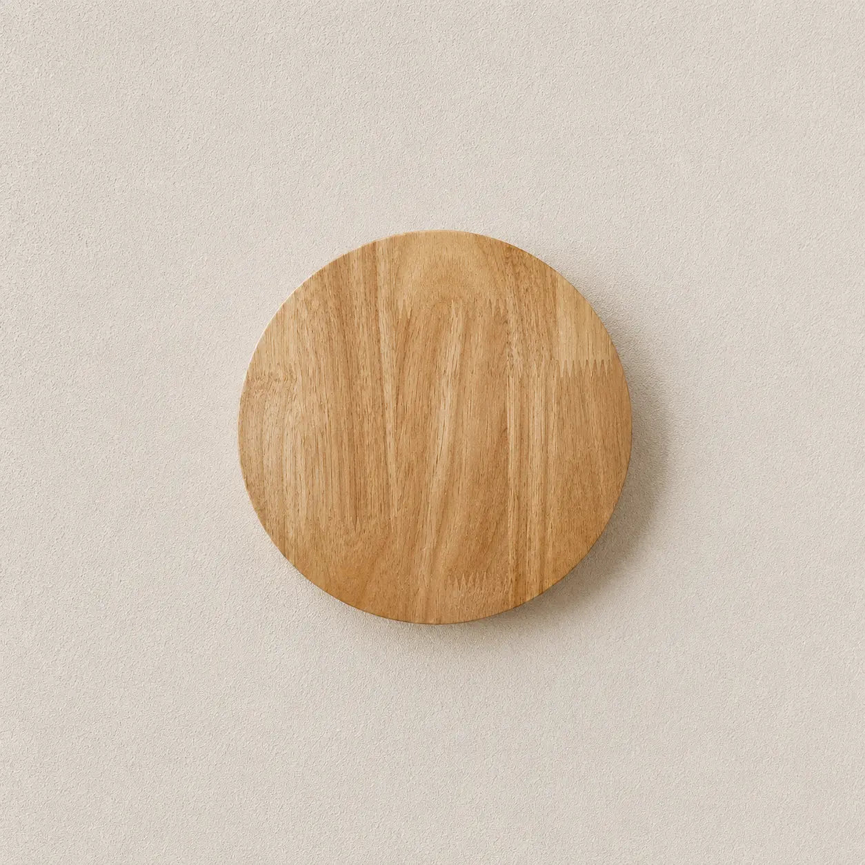 Orvane wooden wall light with a round wood-finish shade and soft warm backlit glow