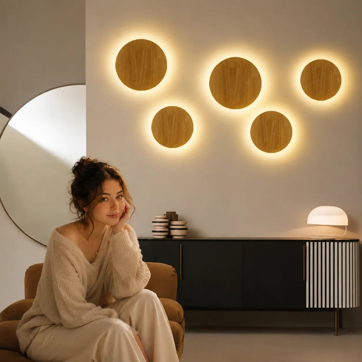 Multiple Orvane wooden wall lights creating warm circular wall glow in a modern living room