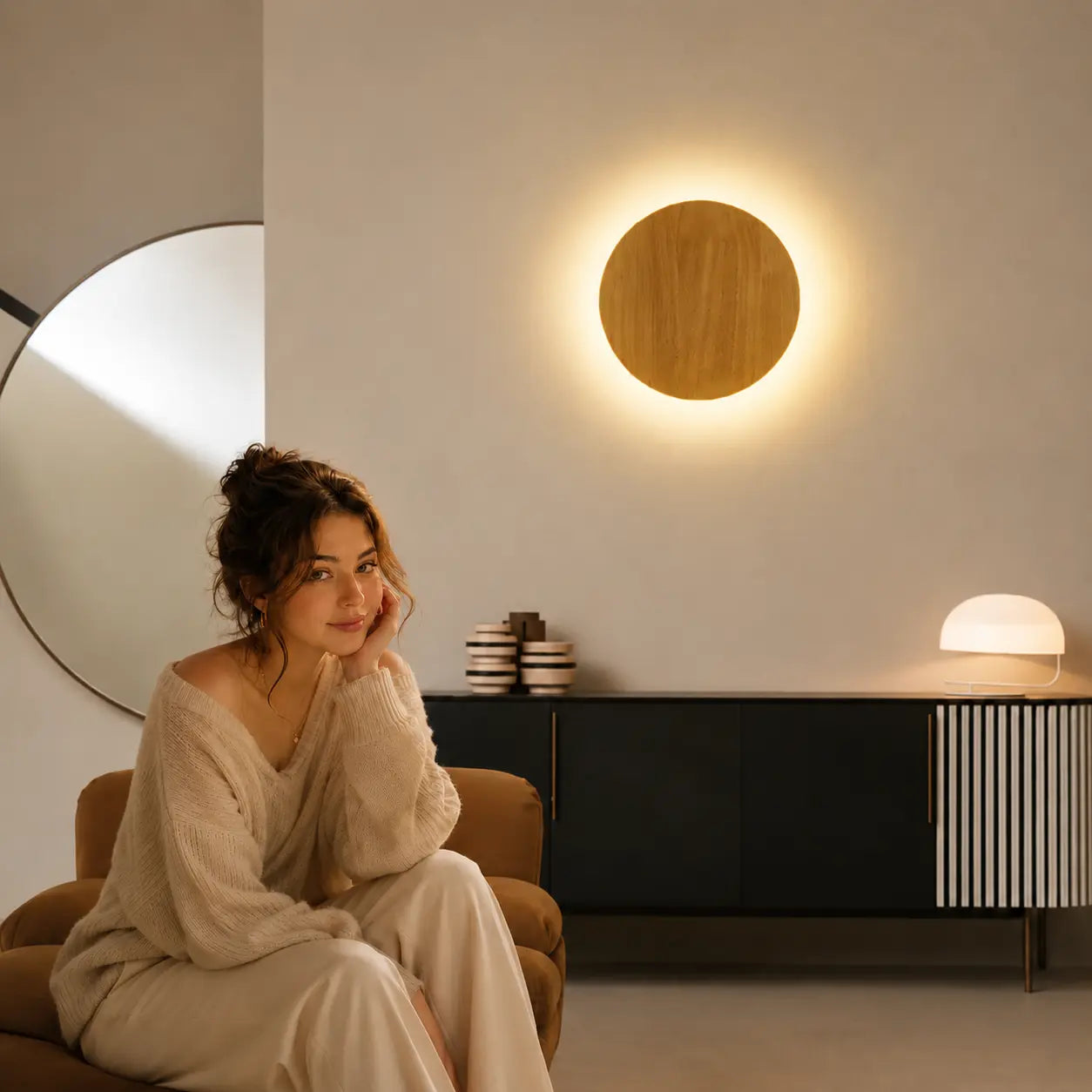 Orvane wooden wall light creating a soft warm glow beside a calm reading corner