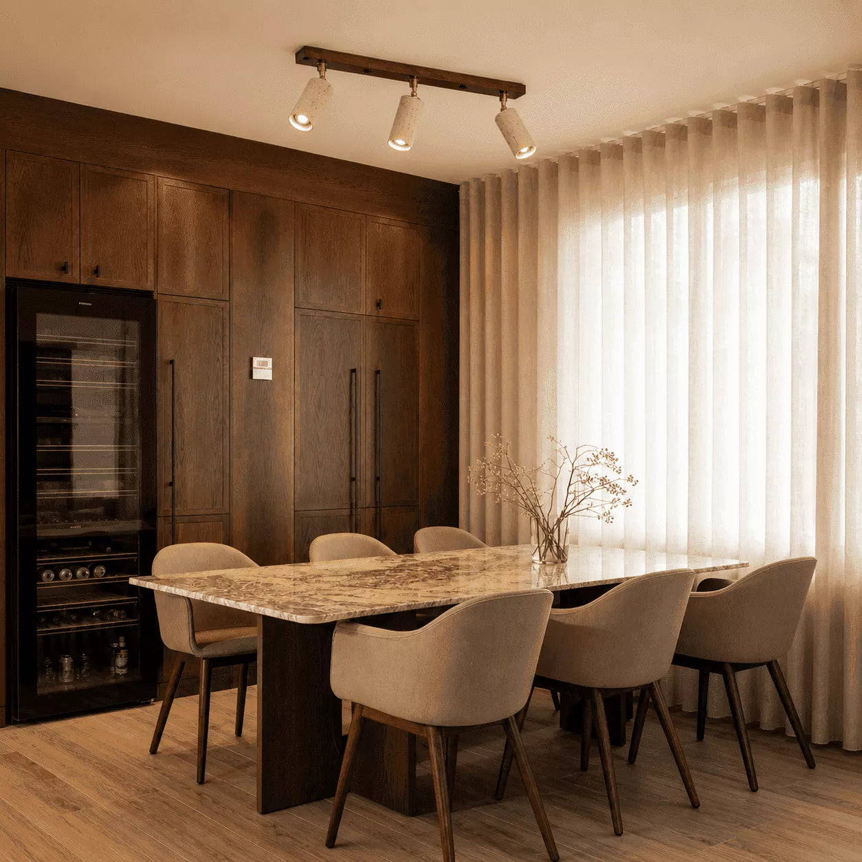 Rhea stone ceiling light creating warm ambient illumination above a modern dining table