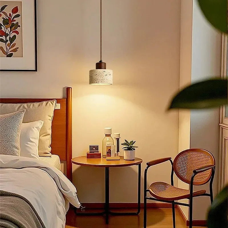 Selo stone pendant light adding warm bedside illumination above a nightstand in a cozy bedroom