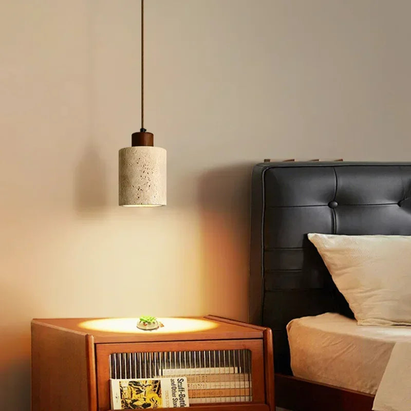 Selo stone pendant light creating a focused warm glow above a bedside table