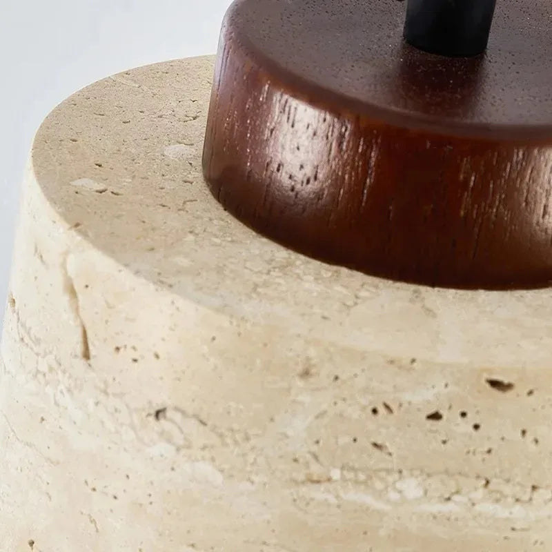 Selo stone pendant light adding soft warm light above a small living room table