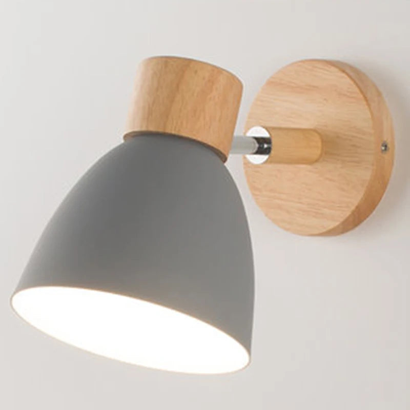 Solenne macaron wall sconce in gray with a natural wood mount and soft downward light