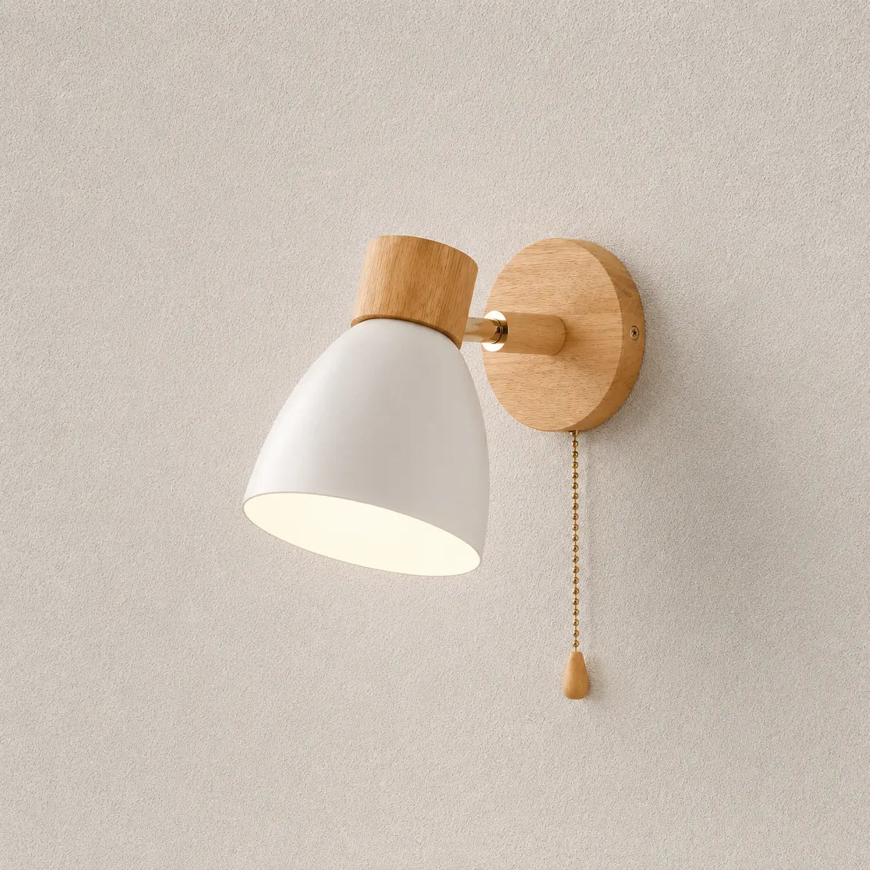 Solenne macaron wall sconce in white with a natural wood mount, pull cord, and warm downward glow