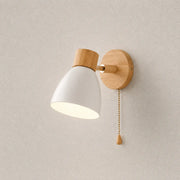 Solenne macaron wall sconce in white with a natural wood mount, pull cord, and warm downward glow