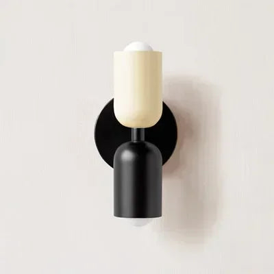 Solvi macaron wall light in black and white with a compact rounded wall-mounted design