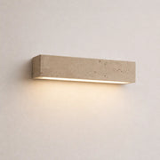 Tarin stone wall light with a slim rectangular stone finish and warm downward glow