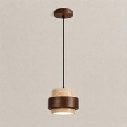 Tova stone pendant light with a textured stone shade, warm wood accent, and soft downward glow