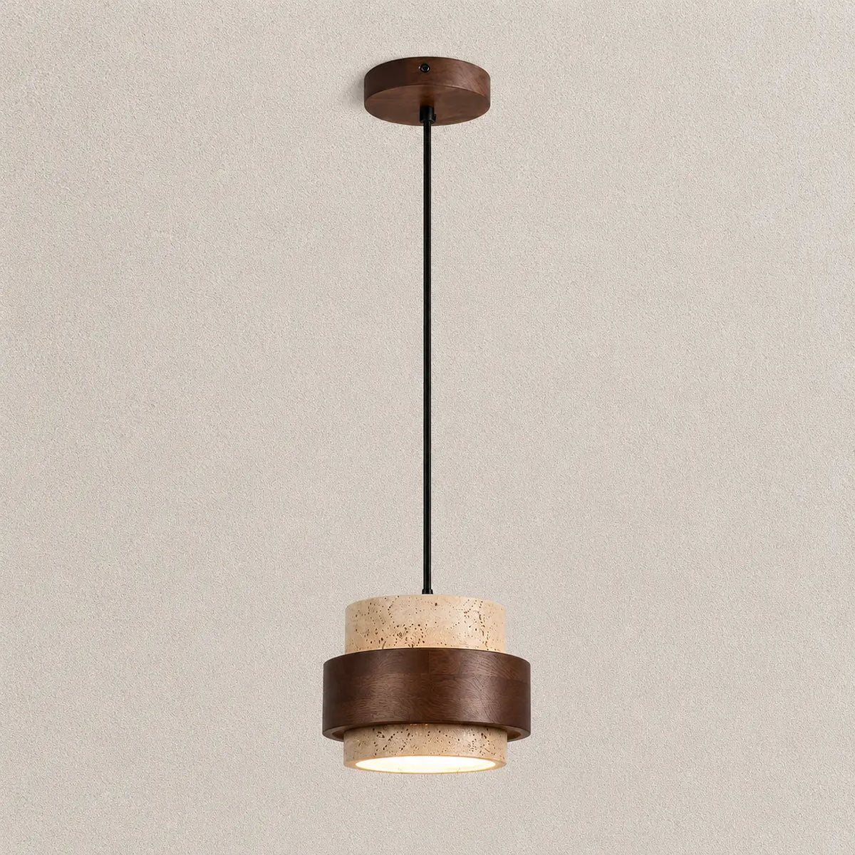 Tova stone pendant light with a textured stone shade, warm wood accent, and soft downward glow