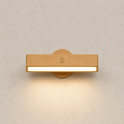 Velmora magnetic wall sconce with a natural wood bar design and soft warm downward glow