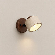 Velor stone wall light with an adjustable textured stone shade, walnut wood mounting base, and warm downward glow