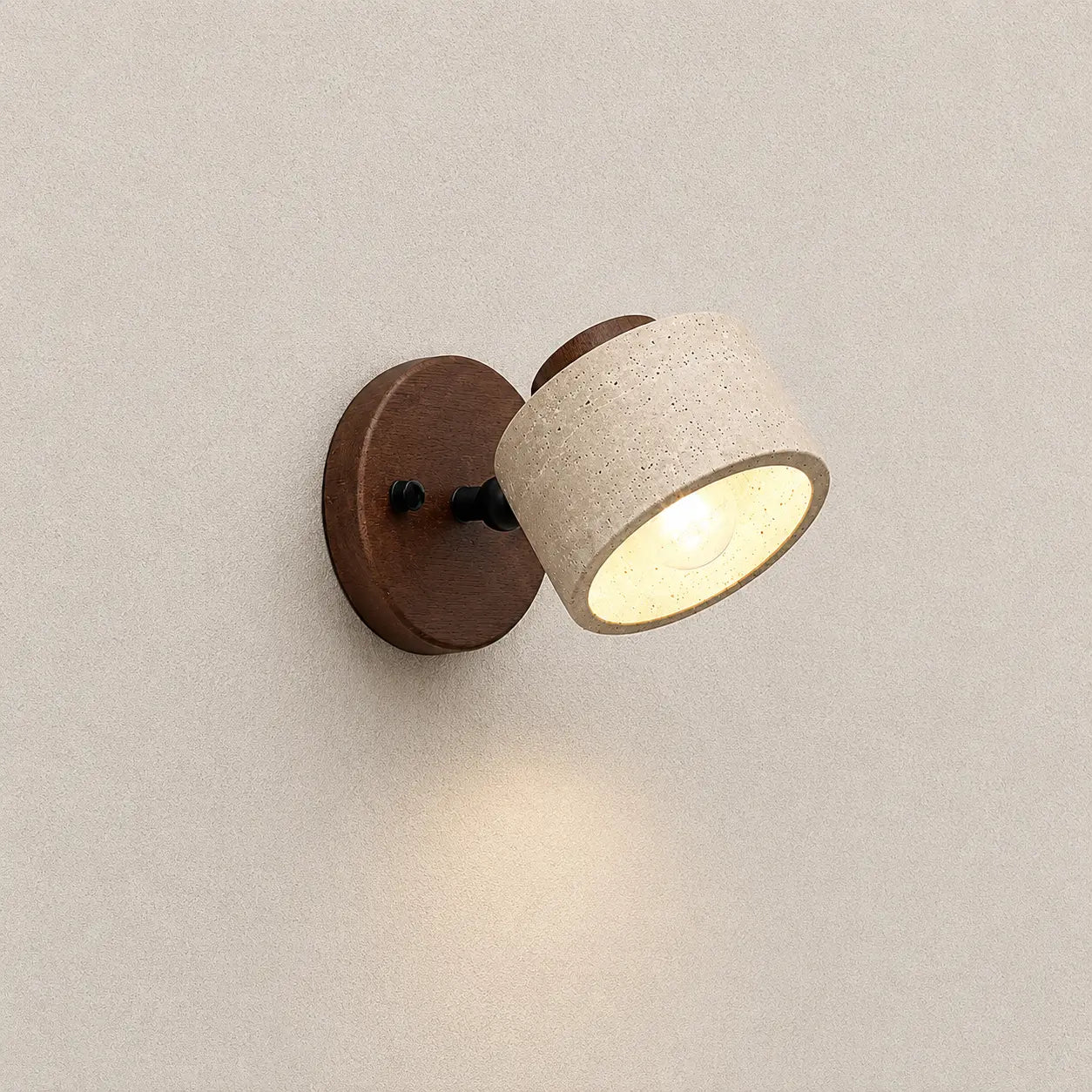 Velor stone wall light with an adjustable textured stone shade, walnut wood mounting base, and warm downward glow