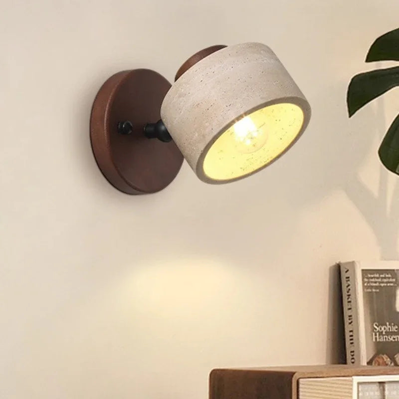 Velor stone wall light installed on a neutral wall with its adjustable shade angled downward