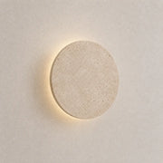 Verno stone wall light with a round textured stone shade and soft warm backlit glow