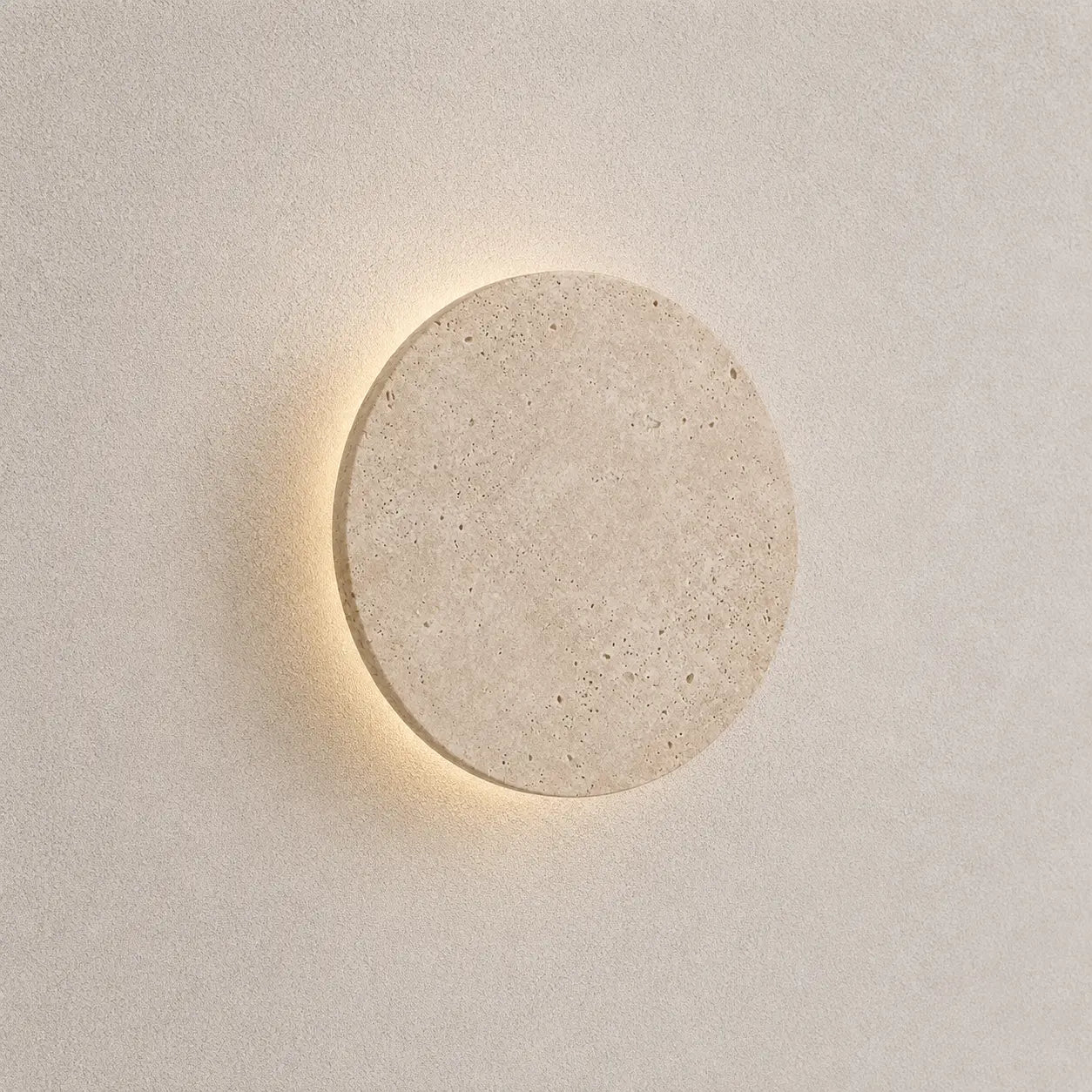Verno stone wall light with a round textured stone shade and soft warm backlit glow